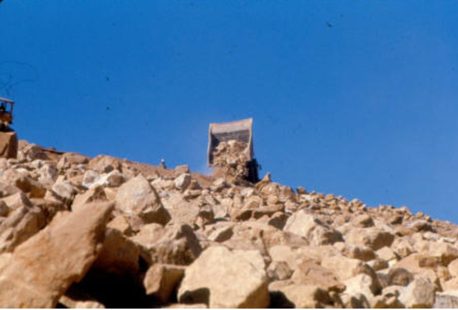 Rock being placed for rip rap slope protection