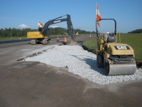 Roller compacting aggregate road base